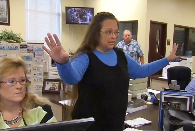 Rowan County Clerk Kim Davis gestures as she refuses to issue marriage licenses to a same-sex couple in Morehead, Kentucky September 1, 2015, in a still image from video provided by WLEX. Davis, defying a new U.S. Supreme Court decision and citing "God's authority," rejected requests for marriage licenses from same-sex couples on Tuesday in a deepening legal standoff now two months old. REUTERS/WLEX/LEX18.com FOR EDITORIAL USE ONLY. NOT FOR SALE FOR MARKETING OR ADVERTISING CAMPAIGNS
